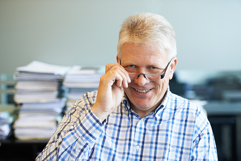 Älterer Herr mit Brille im Büro